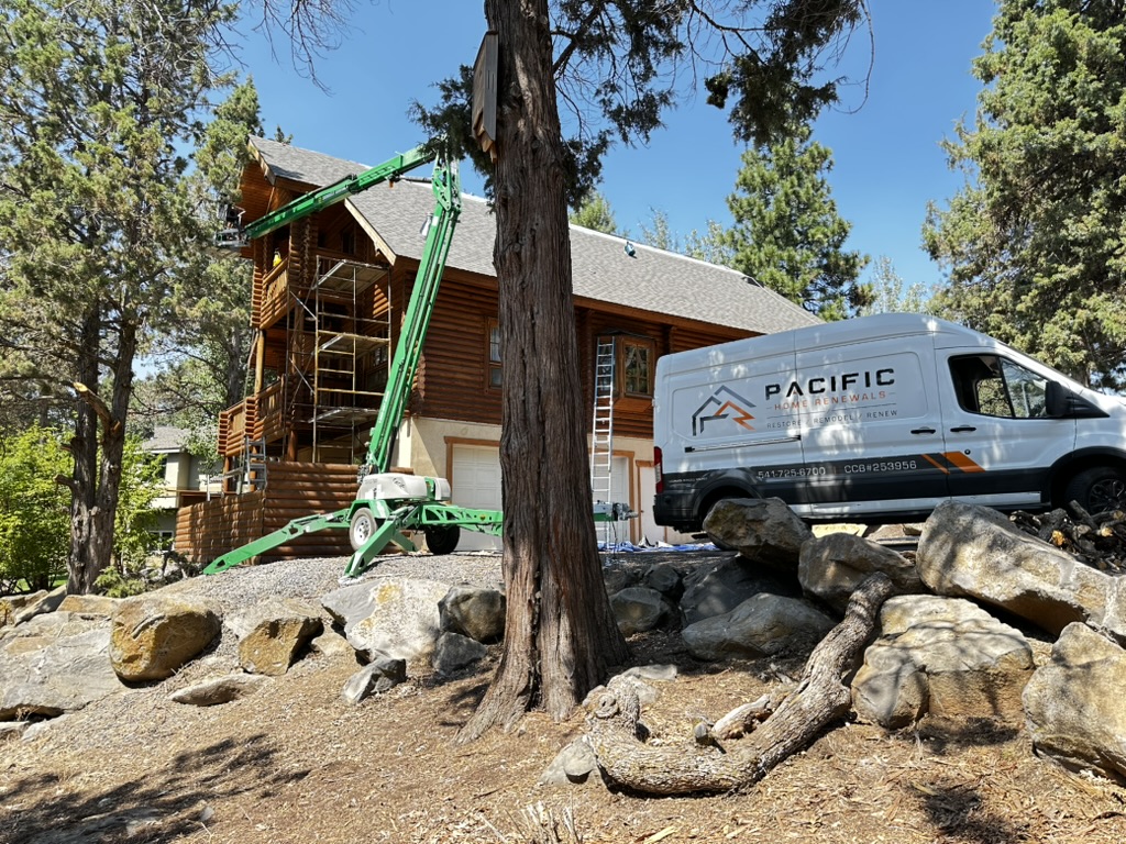 Pacific Home Renewals van and crew on-site restoring a large Oregon log home